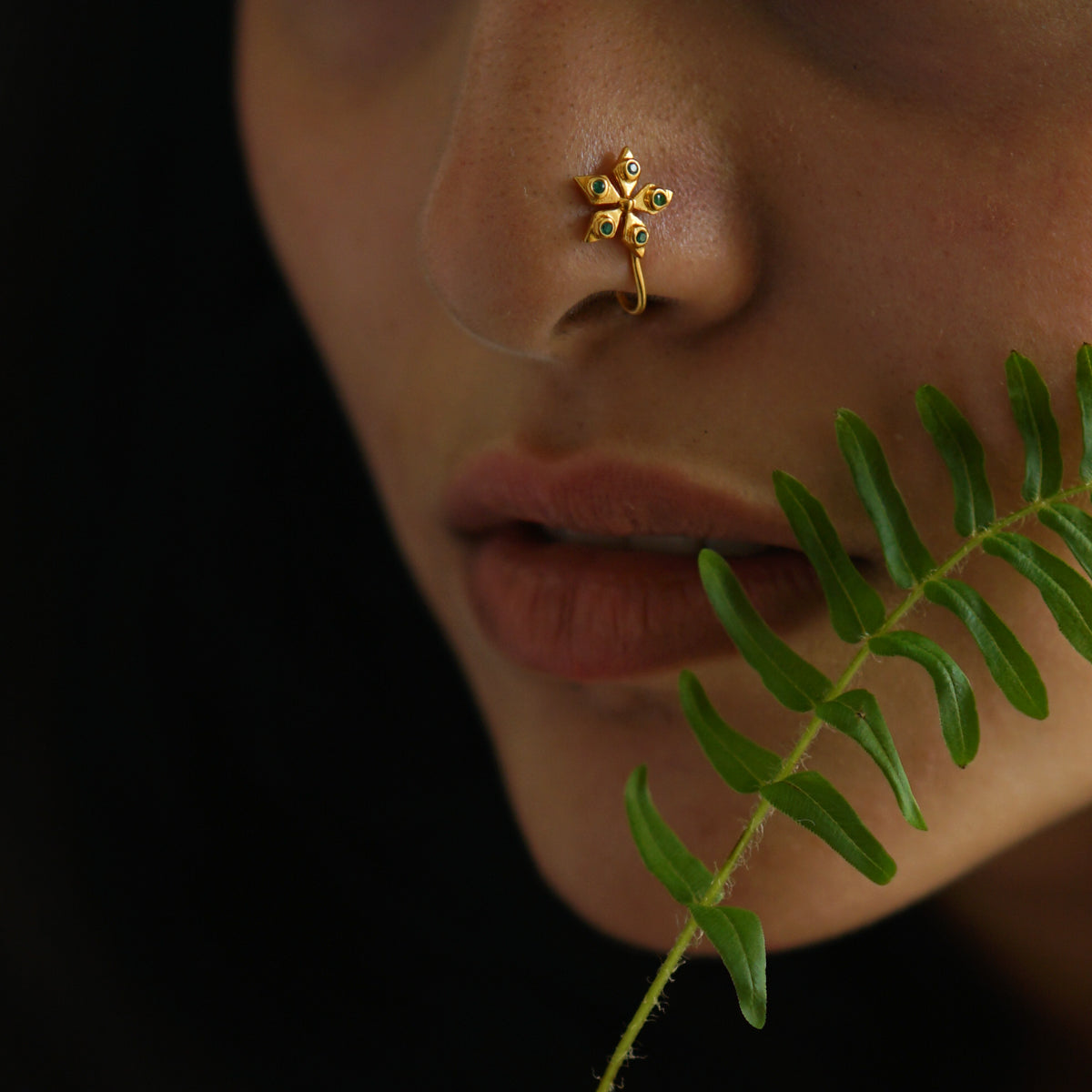 a close up of a person with a nose piercing