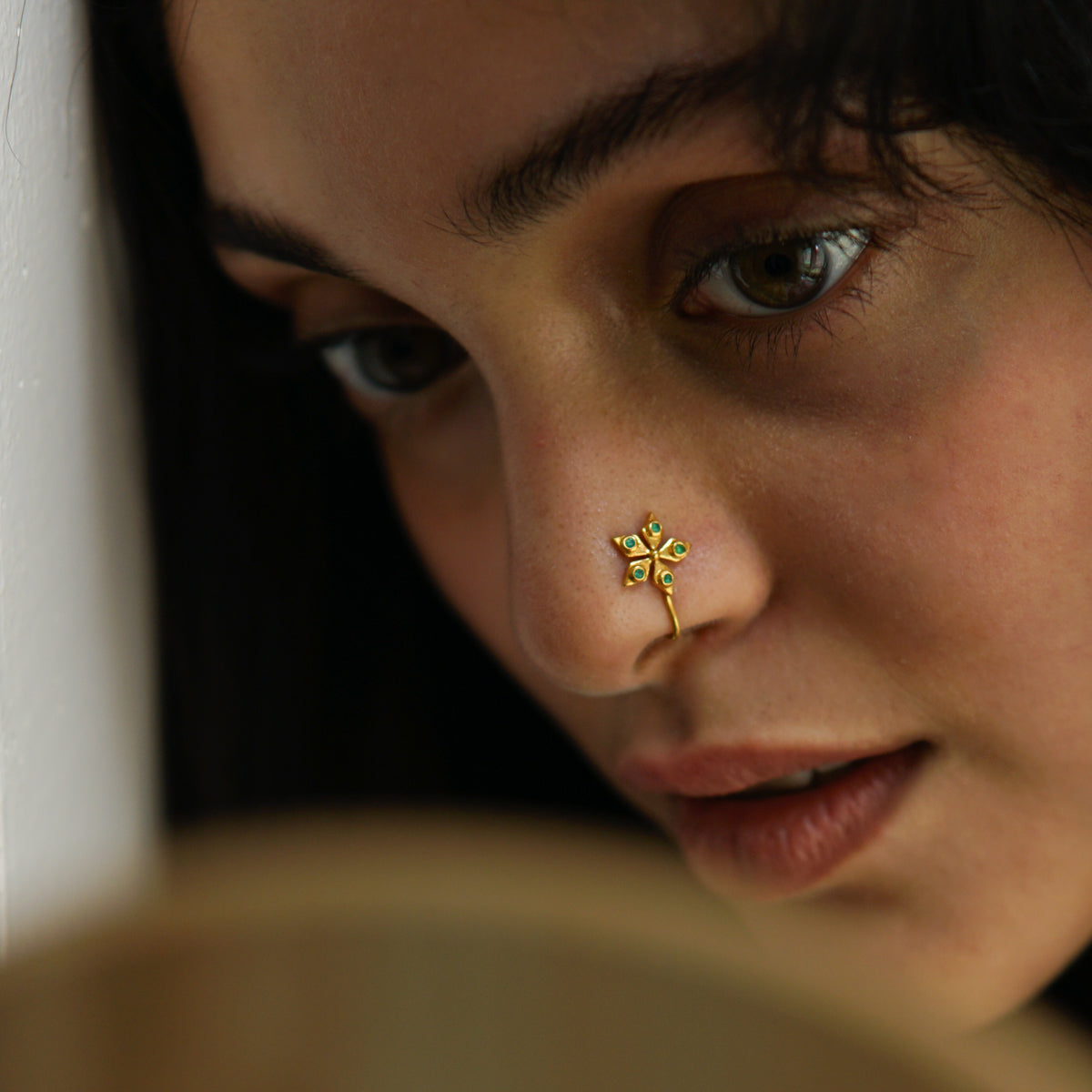 a close up of a person with a nose piercing
