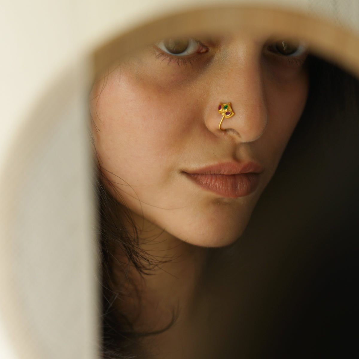 a close up of a person with a nose piercing