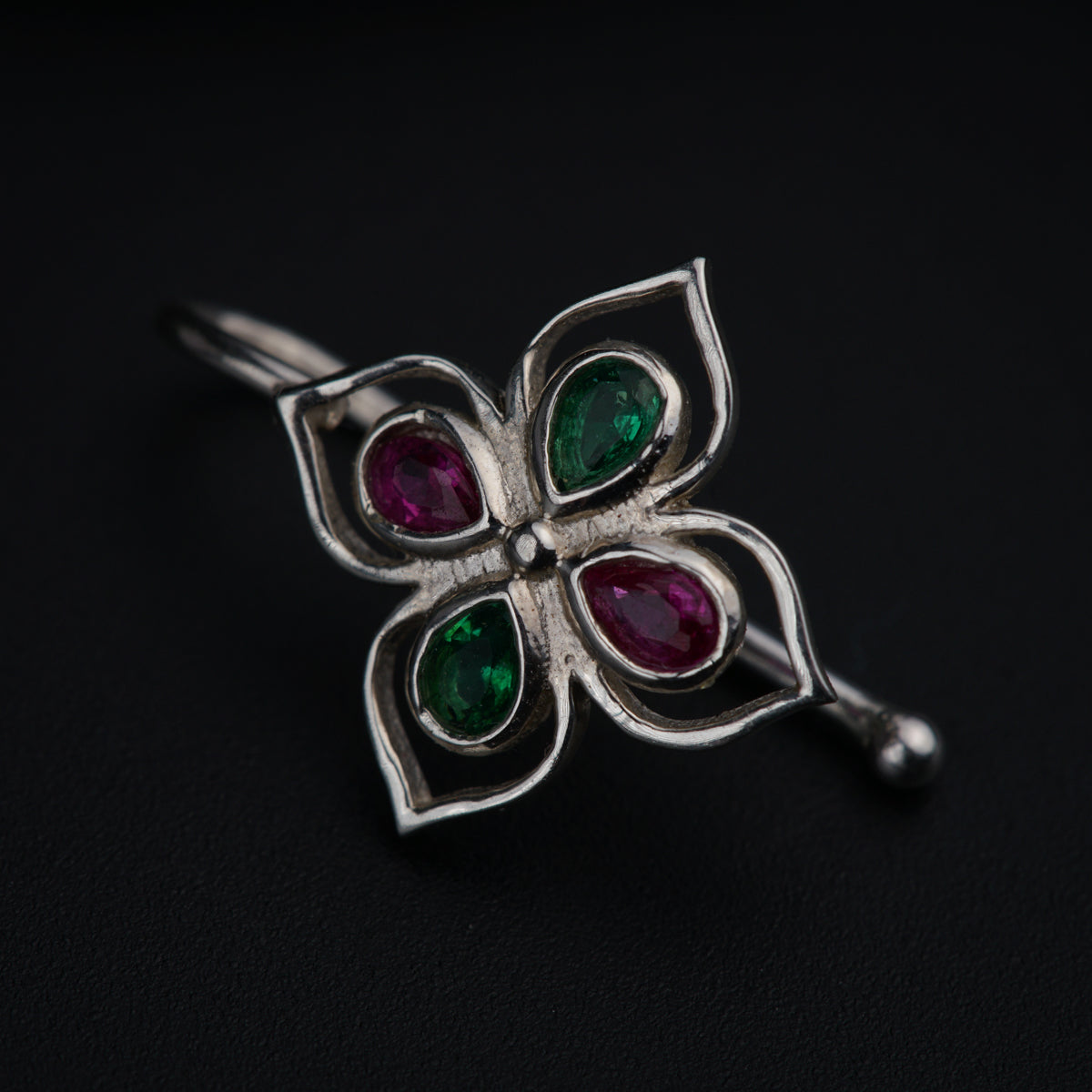a close up of a flower shaped brooch