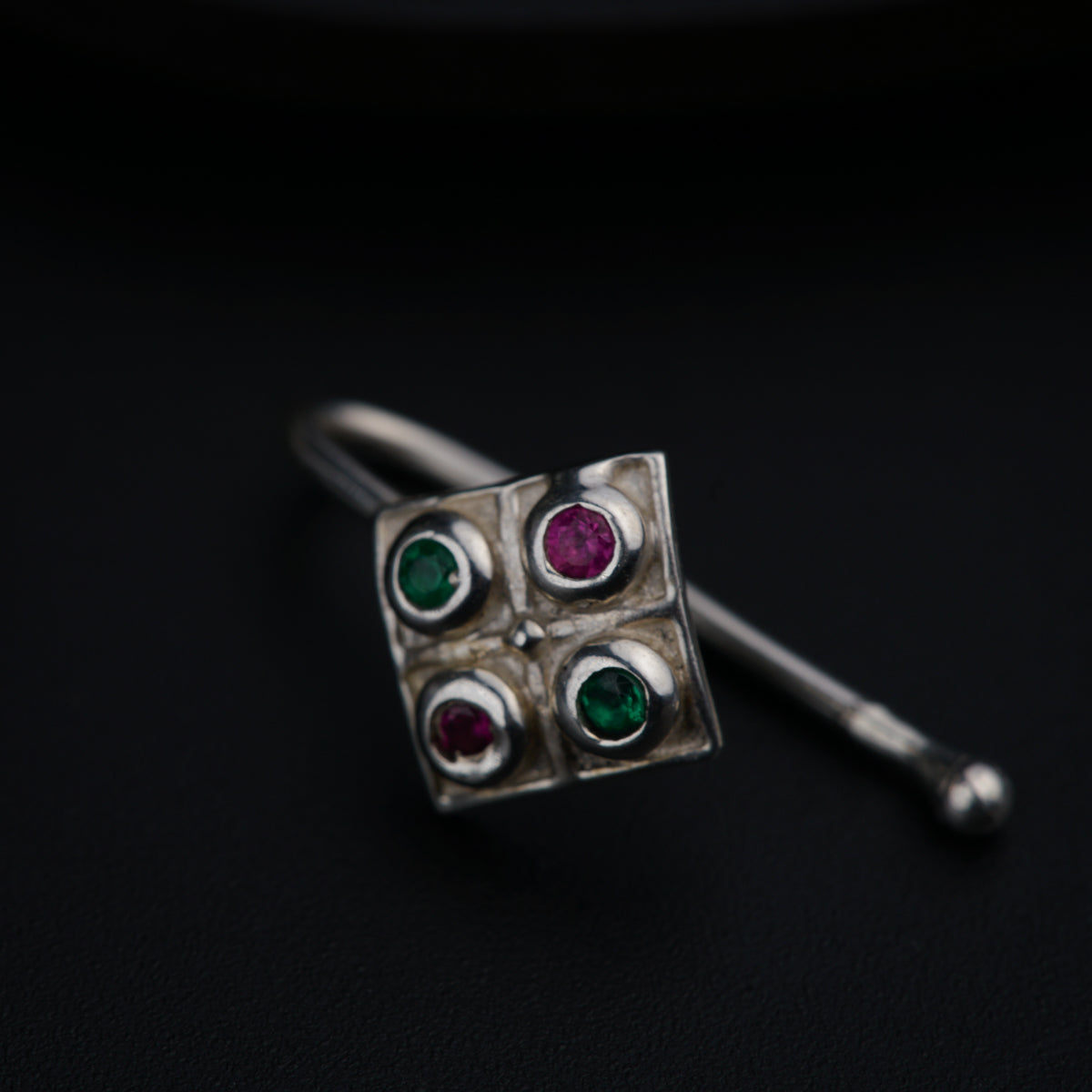 a close up of a pair of earrings on a black surface