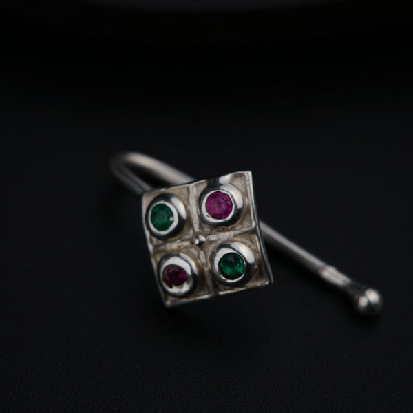 a close up of a pair of earrings on a black surface