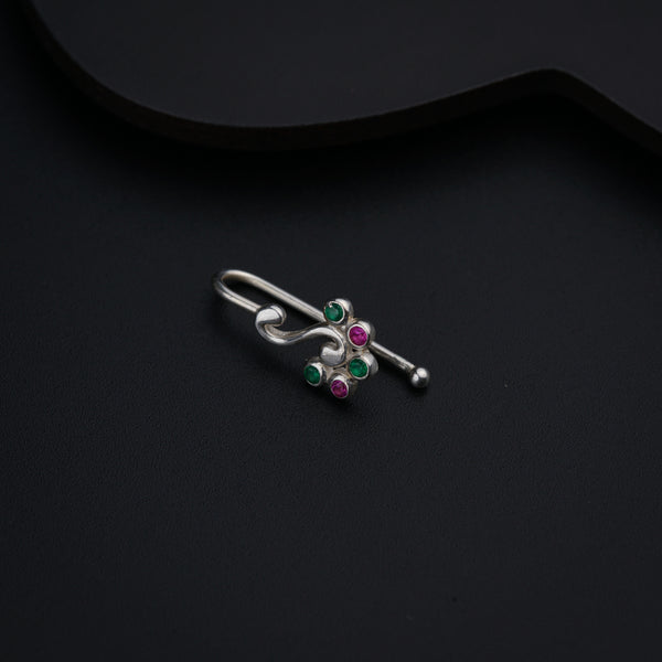 a pair of silver earrings with green and pink stones