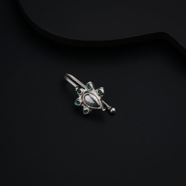 a close up of a brooch on a black surface
