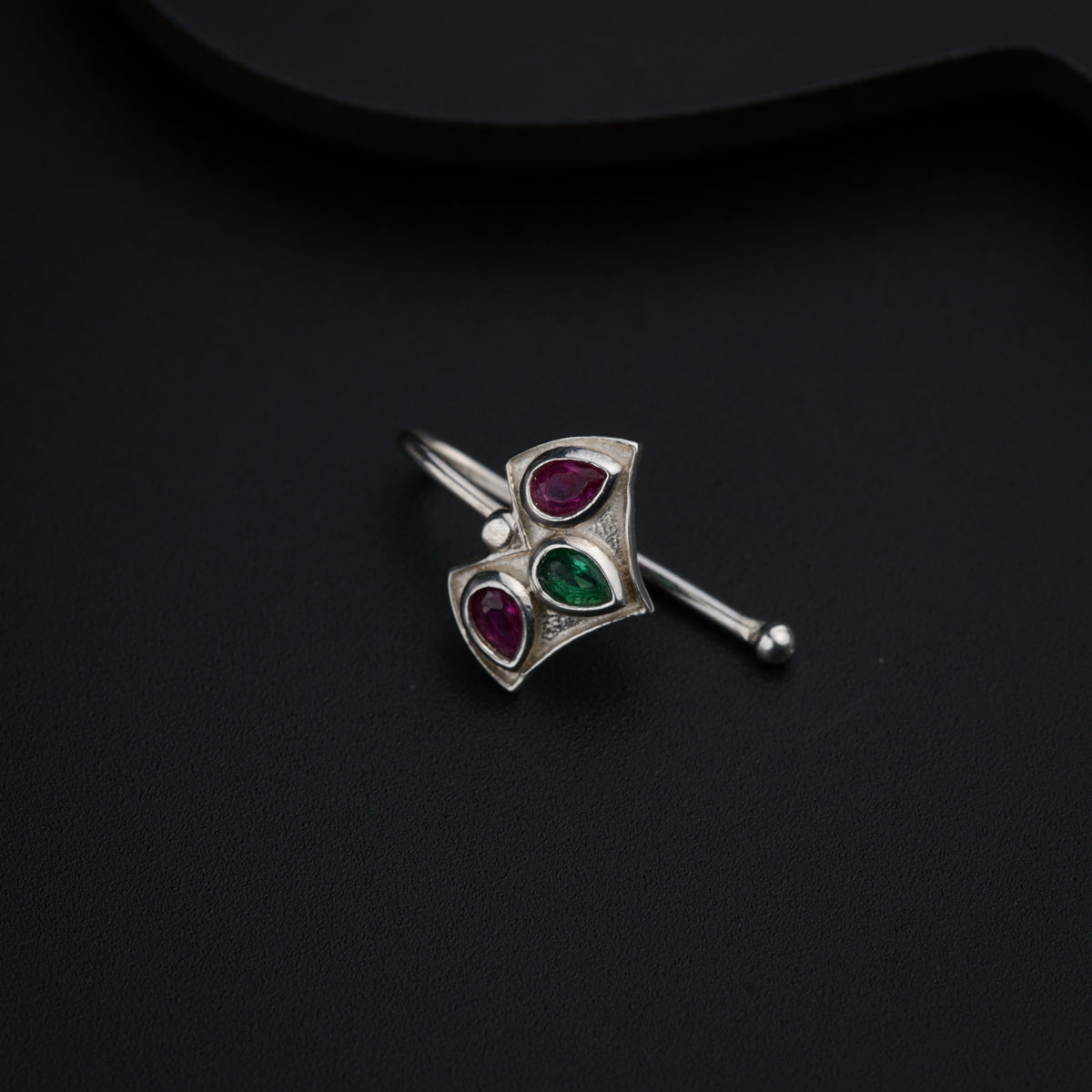 a silver brooch with three stones on it