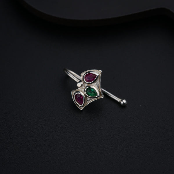 a silver brooch with three stones on it