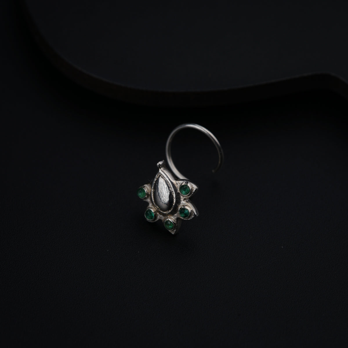 a close up of a ring on a black surface
