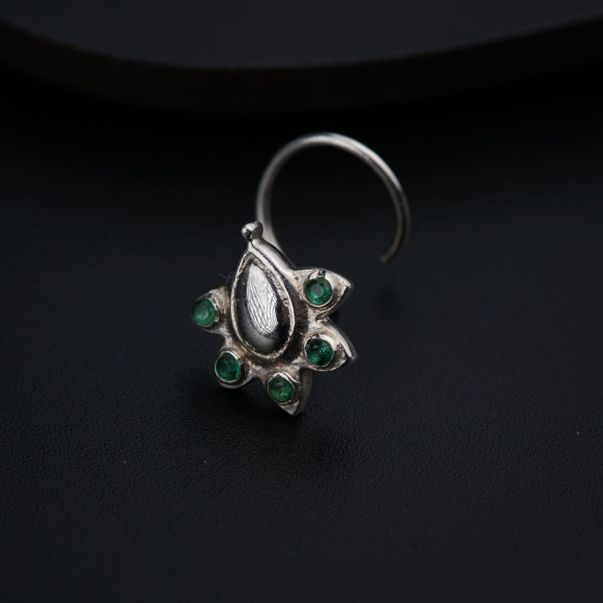 a close up of a ring on a black surface