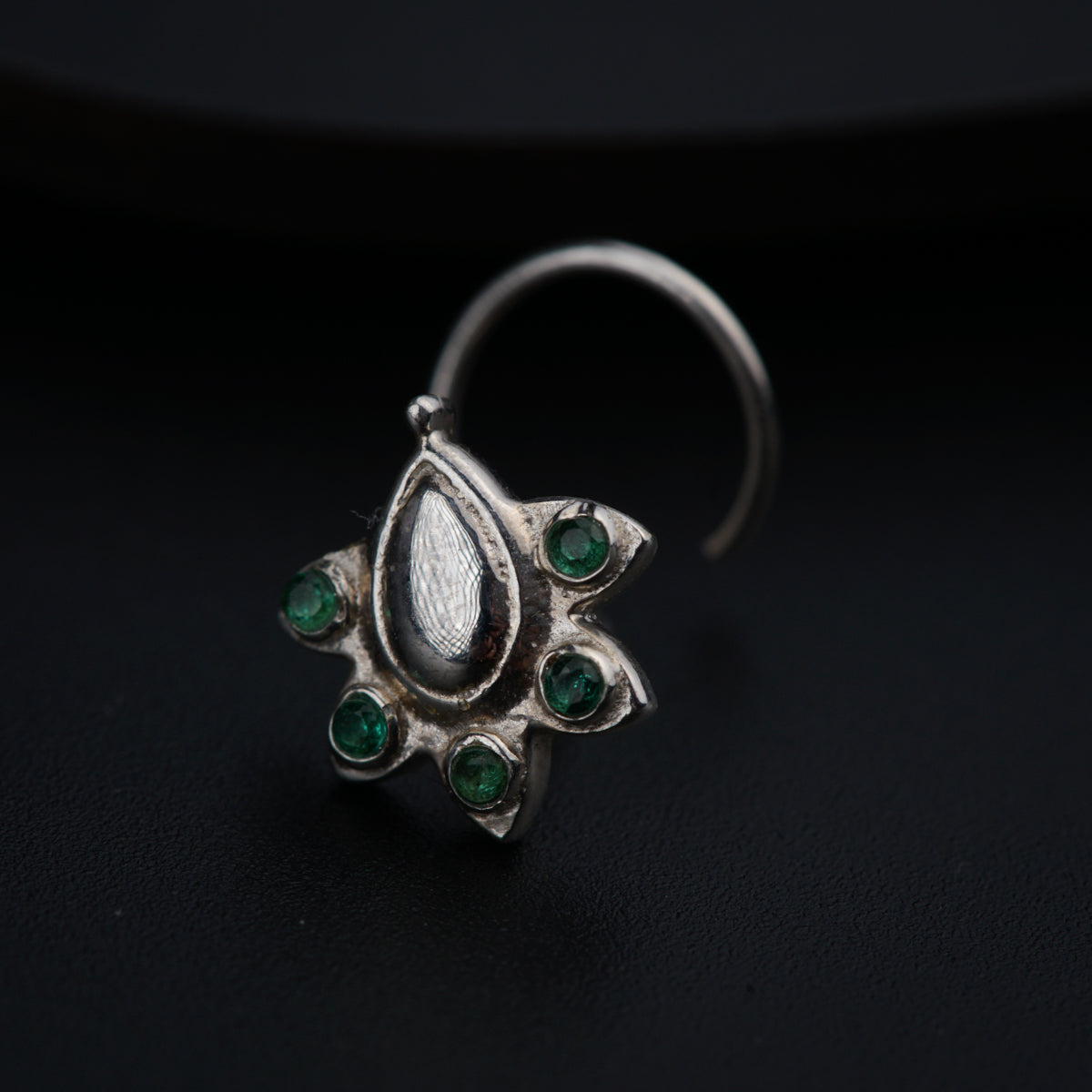 a close up of a ring on a black surface