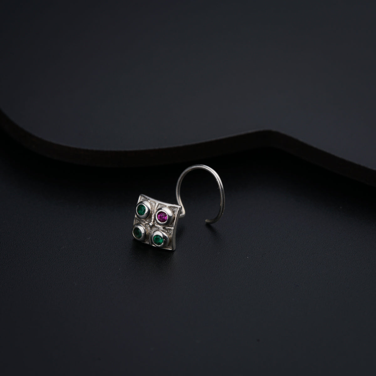 a close up of a ring on a black surface
