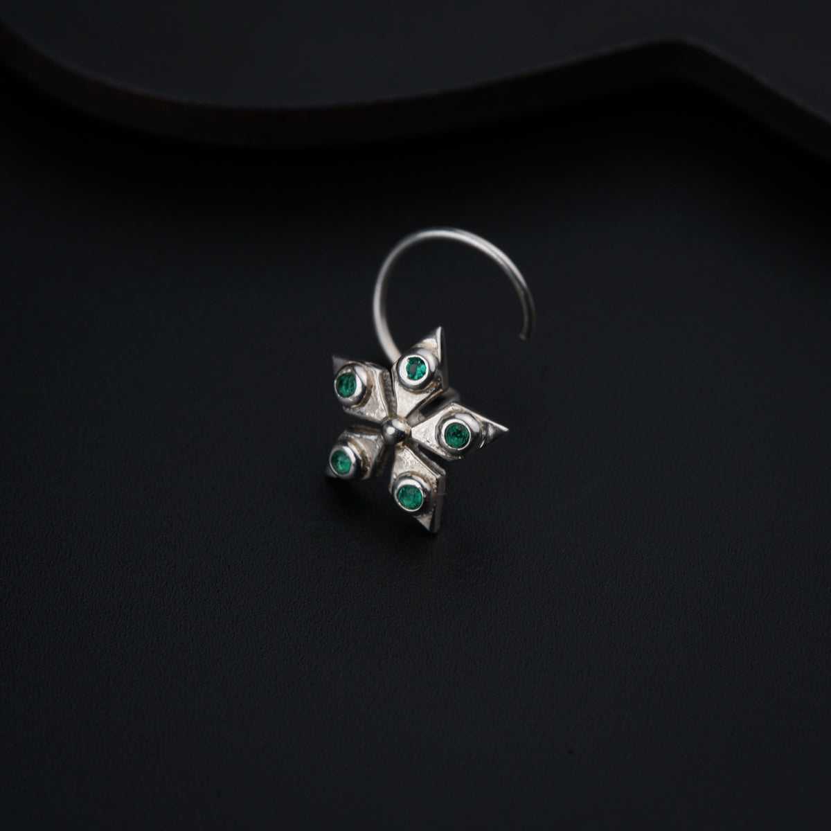 a close up of a ring on a black surface