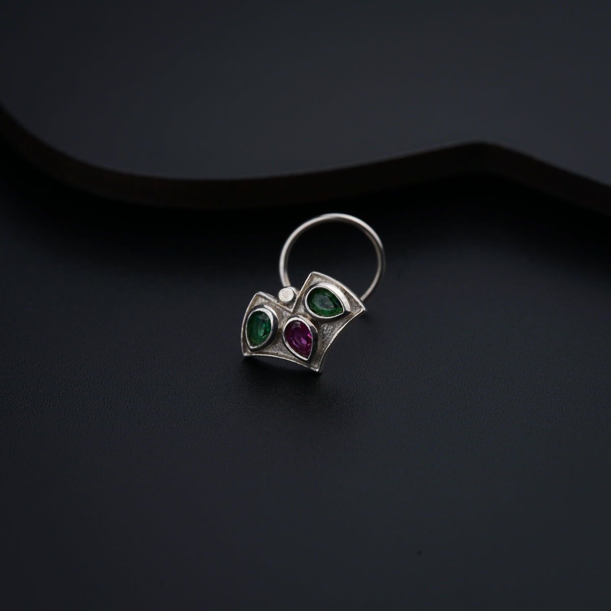 a close up of a ring on a black surface