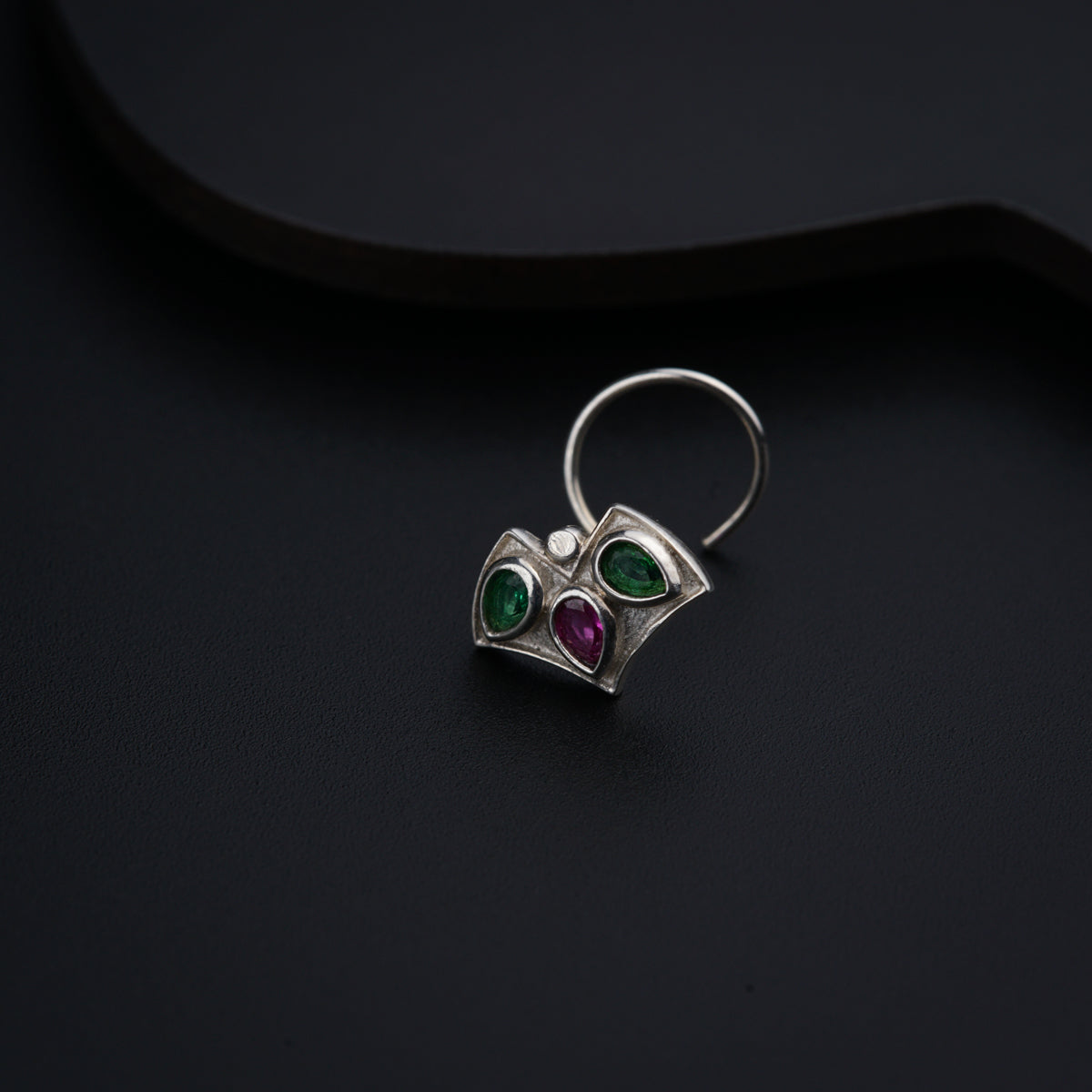 a close up of a ring on a black surface