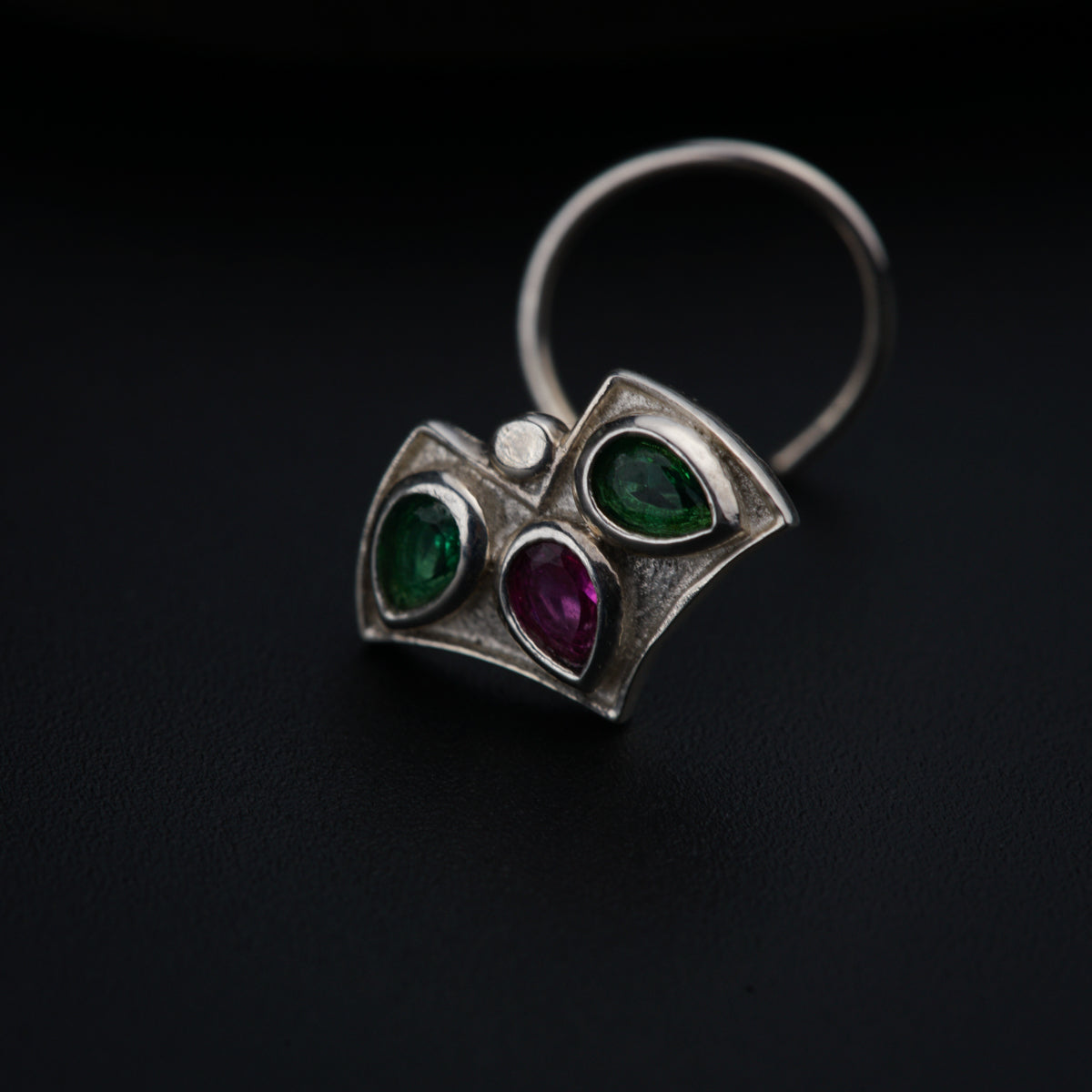 a close up of a ring on a black surface