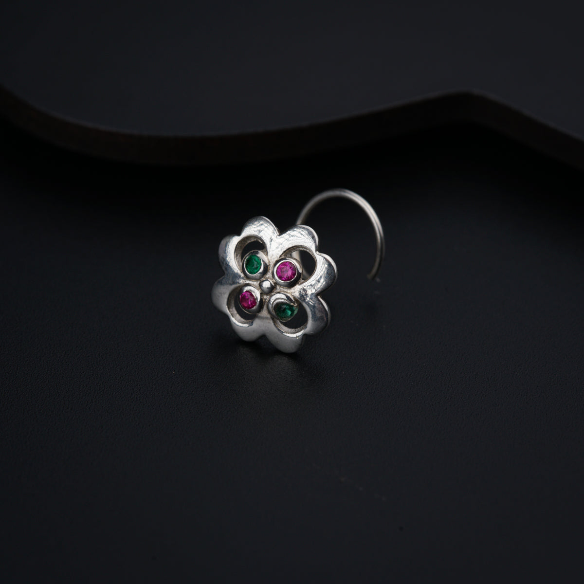 a close up of a ring on a black surface