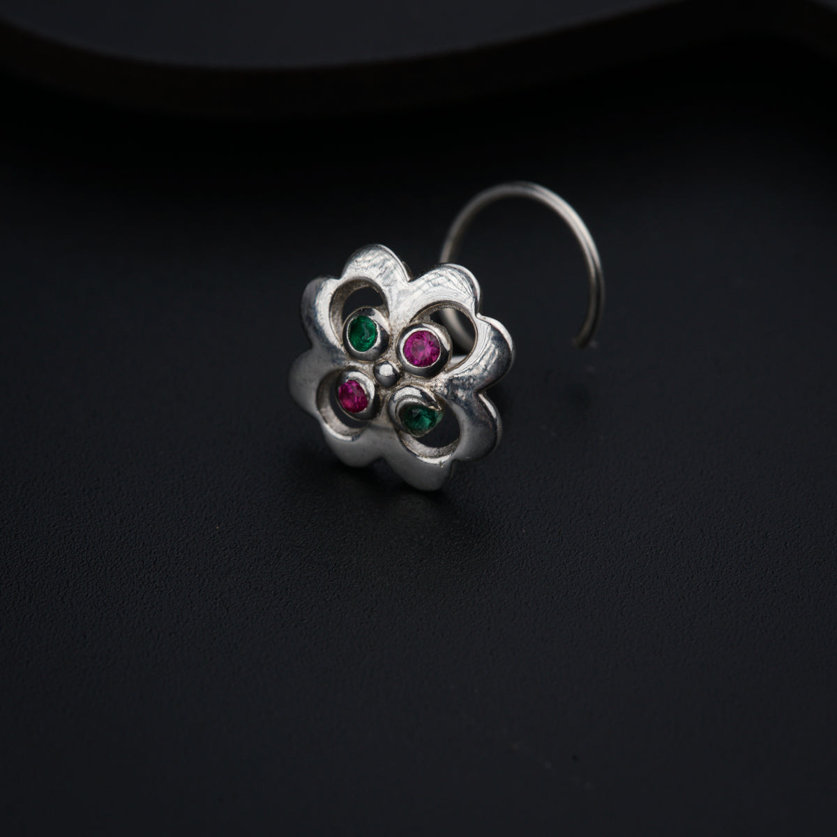 a close up of a ring on a black surface