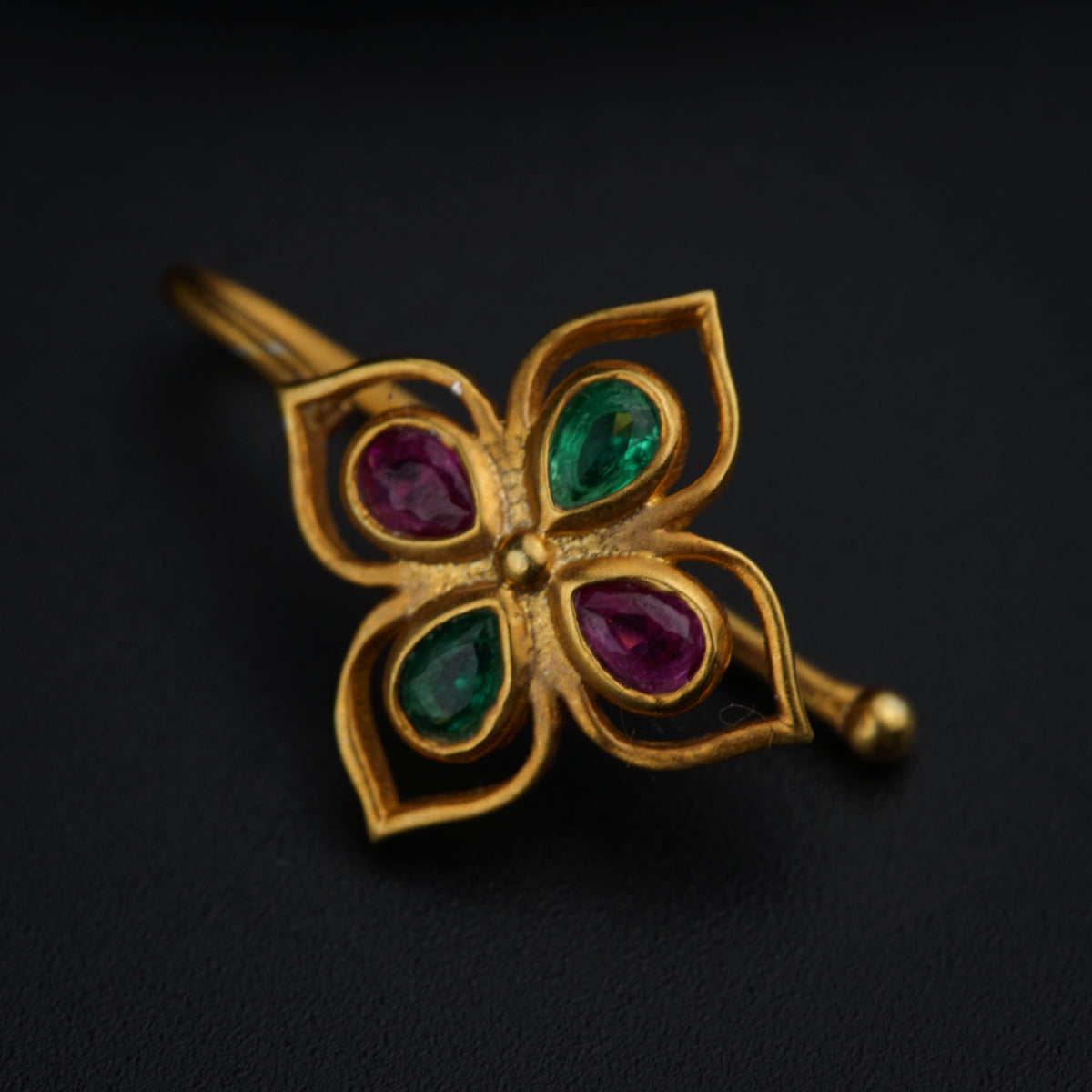 a close up of a flower shaped brooch