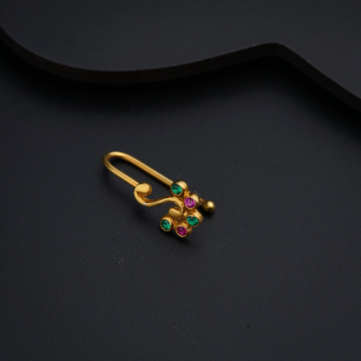 a pair of gold earrings with multi - colored stones