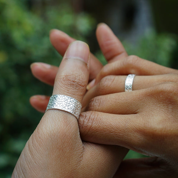 Textured couple rings on finger