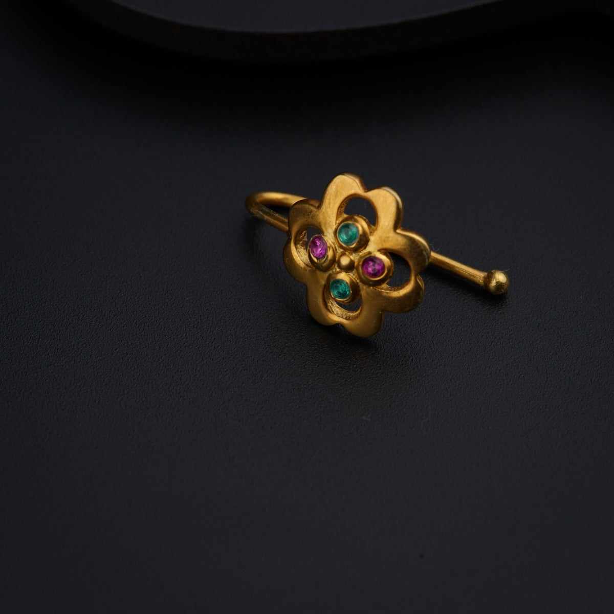 a close up of a ring on a black surface