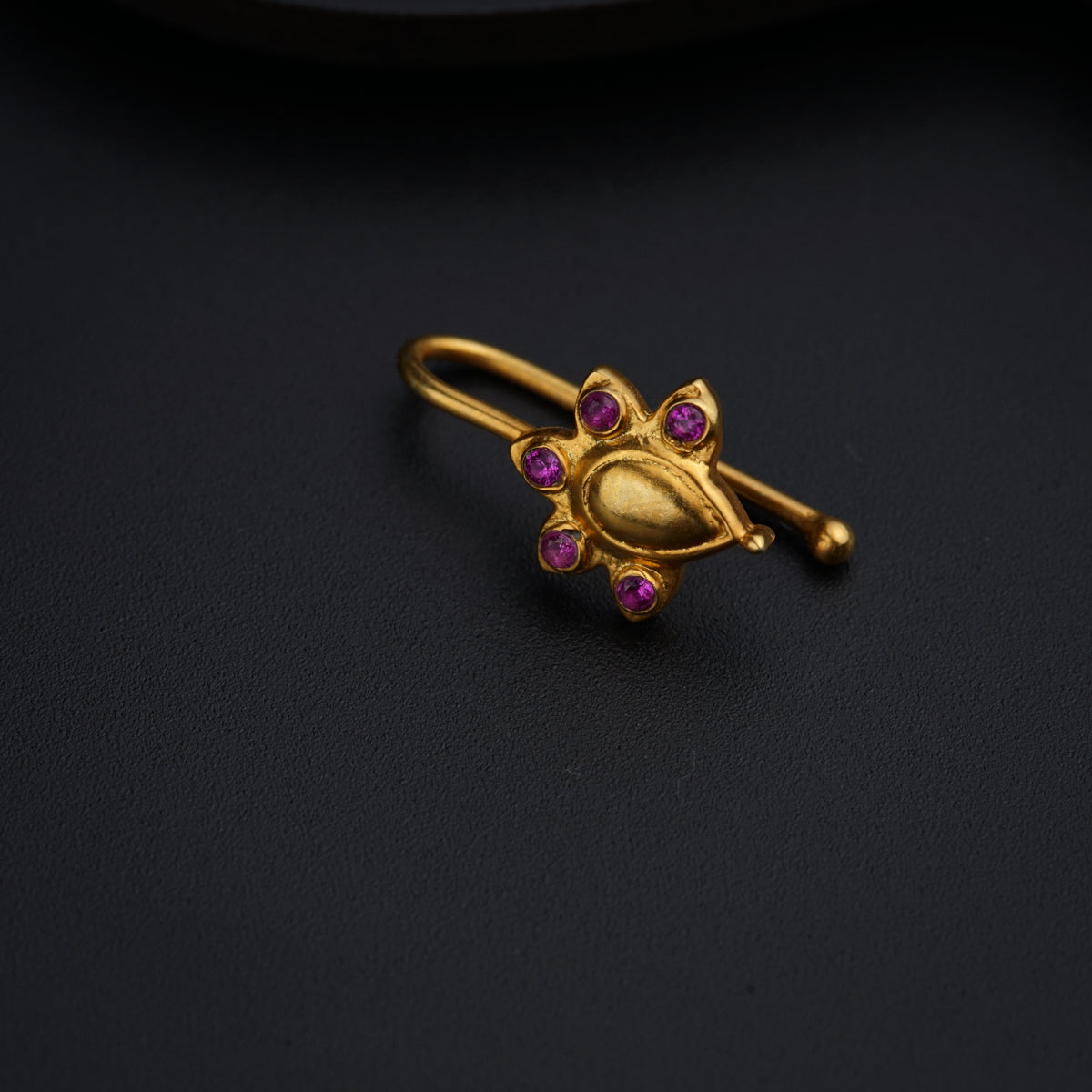 a close up of a ring on a black surface