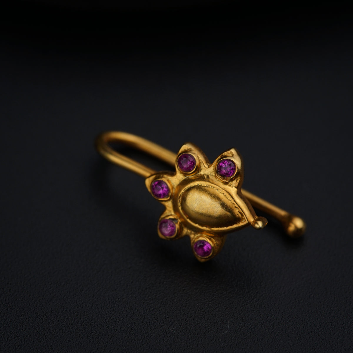 a close up of a ring on a black surface
