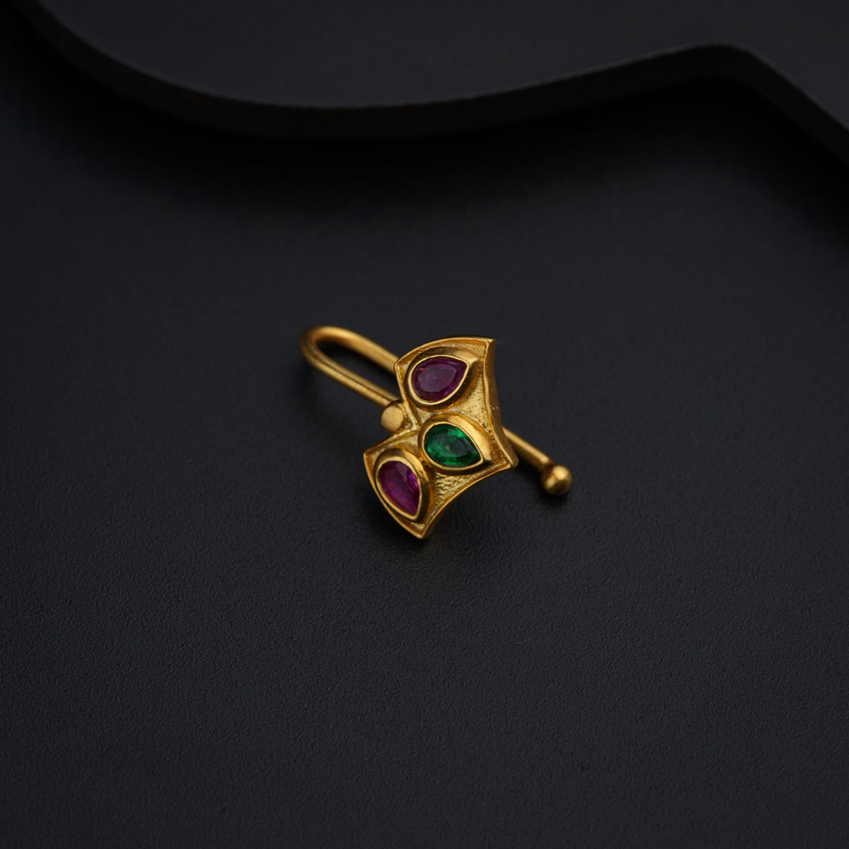 a close up of a ring on a black surface