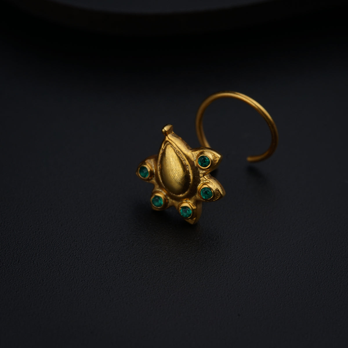 a close up of a ring on a black surface