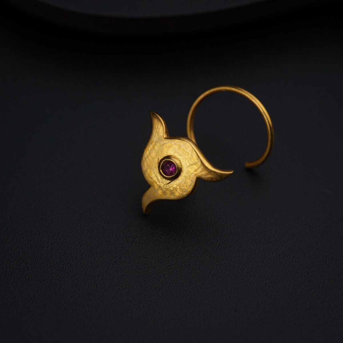a close up of a ring on a black surface