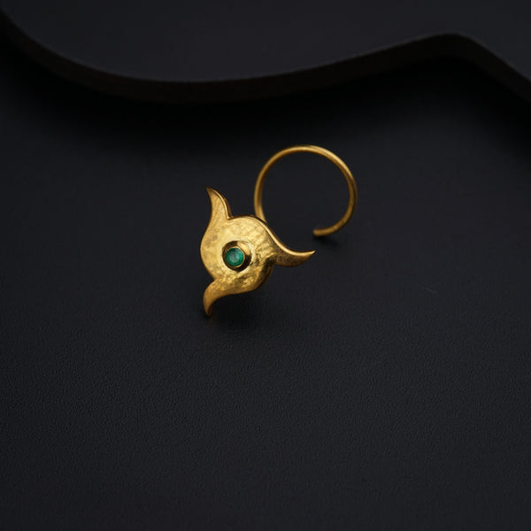 a gold ring with a green stone in the middle