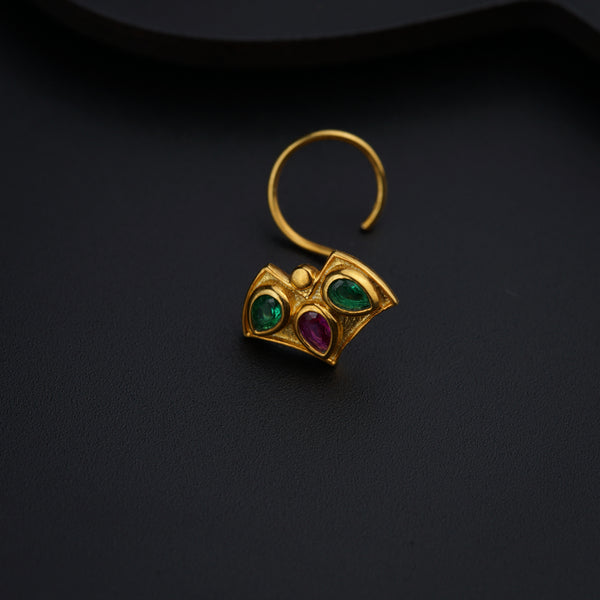 a close up of a pair of earrings on a black surface