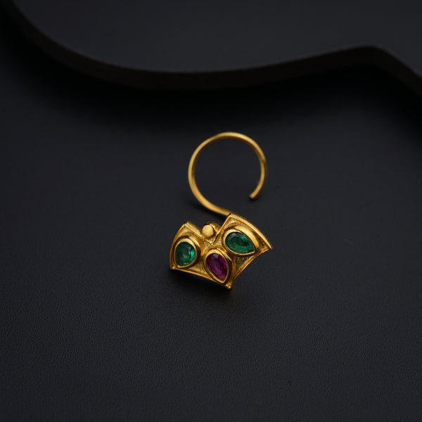 a close up of a pair of earrings on a black surface