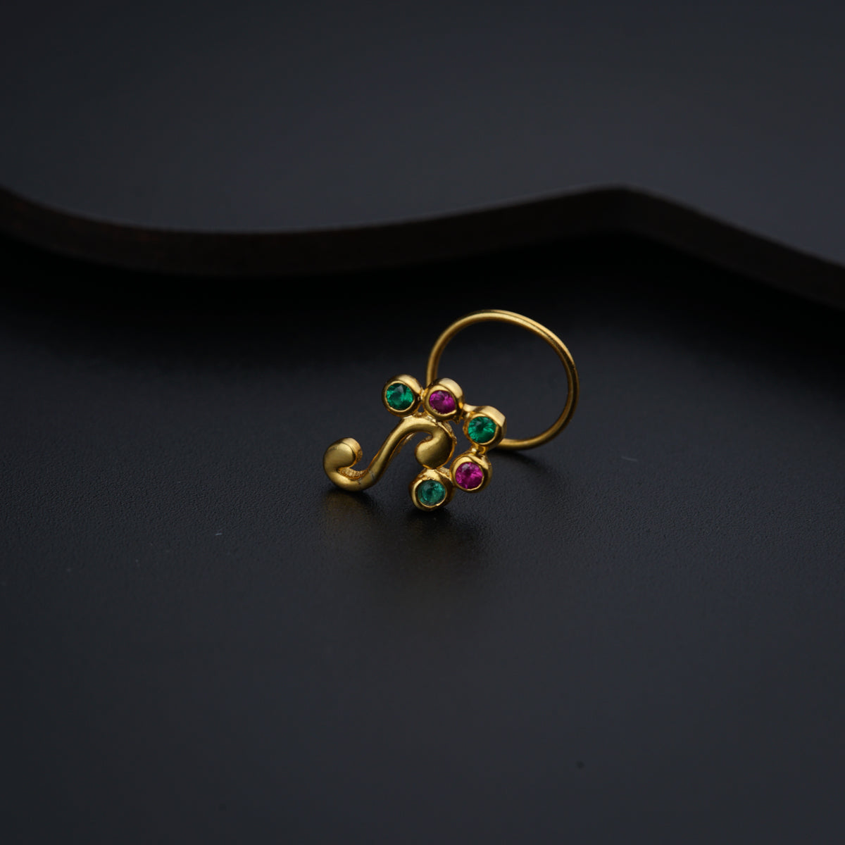 a close up of a ring on a black surface