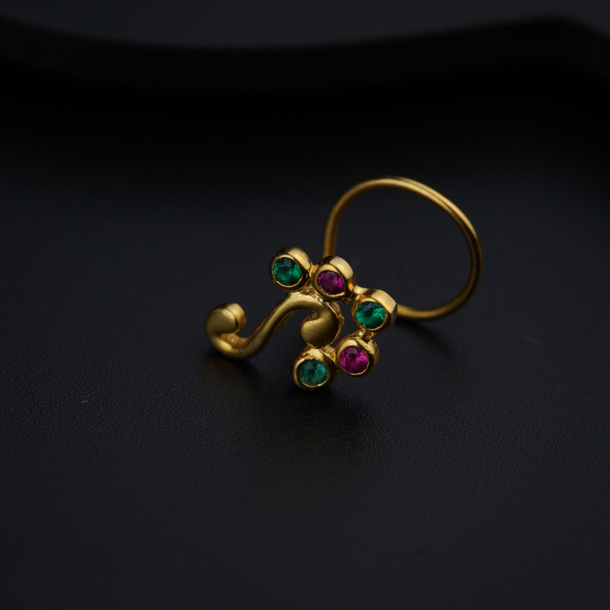 a close up of a ring on a black surface