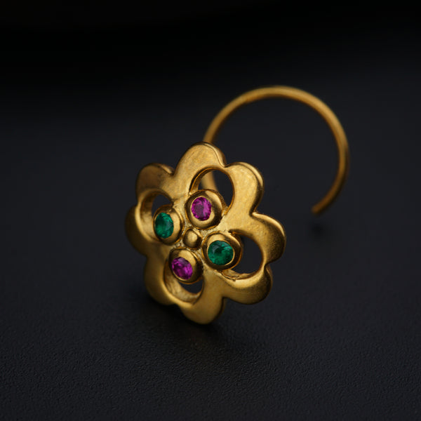 a close up of a pair of earrings on a black surface