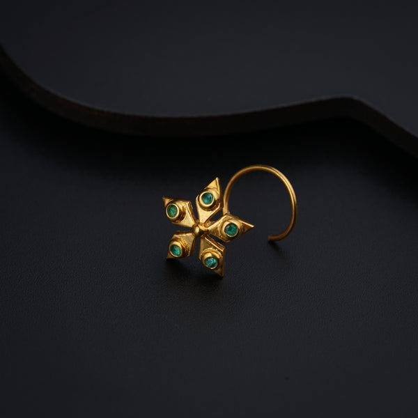 a pair of gold earrings with green stones