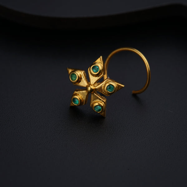 a close up of a pair of earrings on a black surface