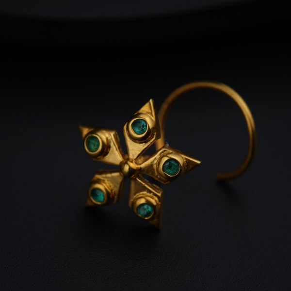 a close up of a pair of earrings on a black surface