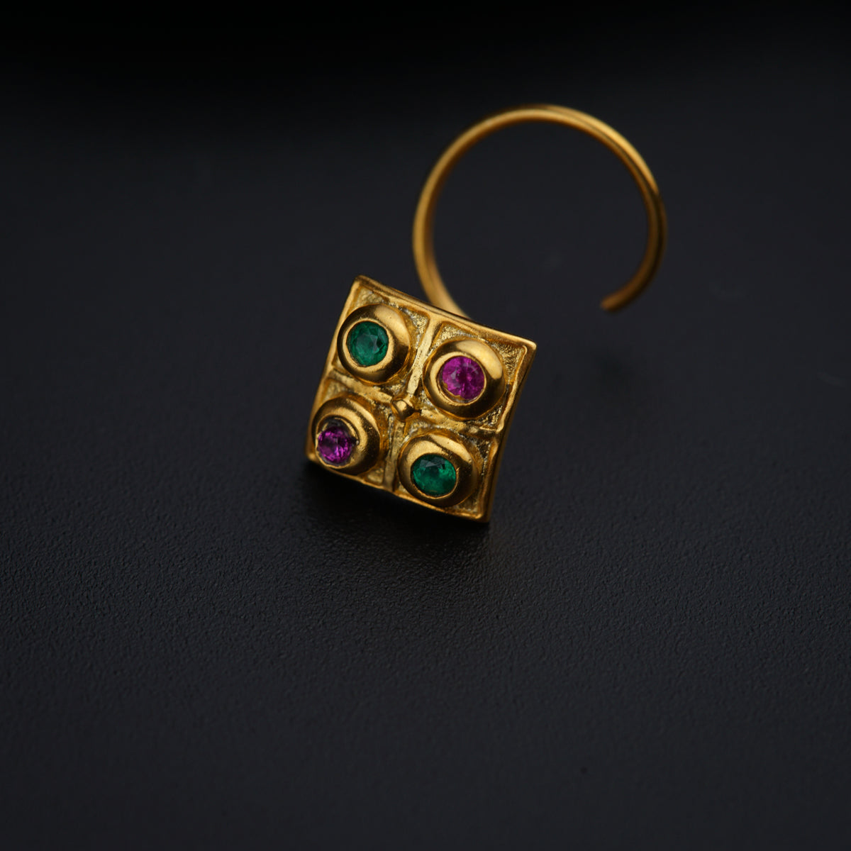 a close up of a ring on a black surface