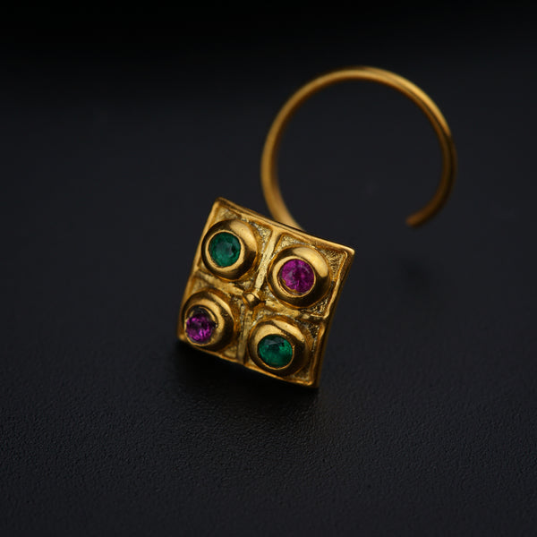 a close up of a pair of earrings on a black surface