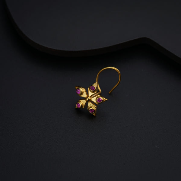 a pair of gold earrings with pink stones