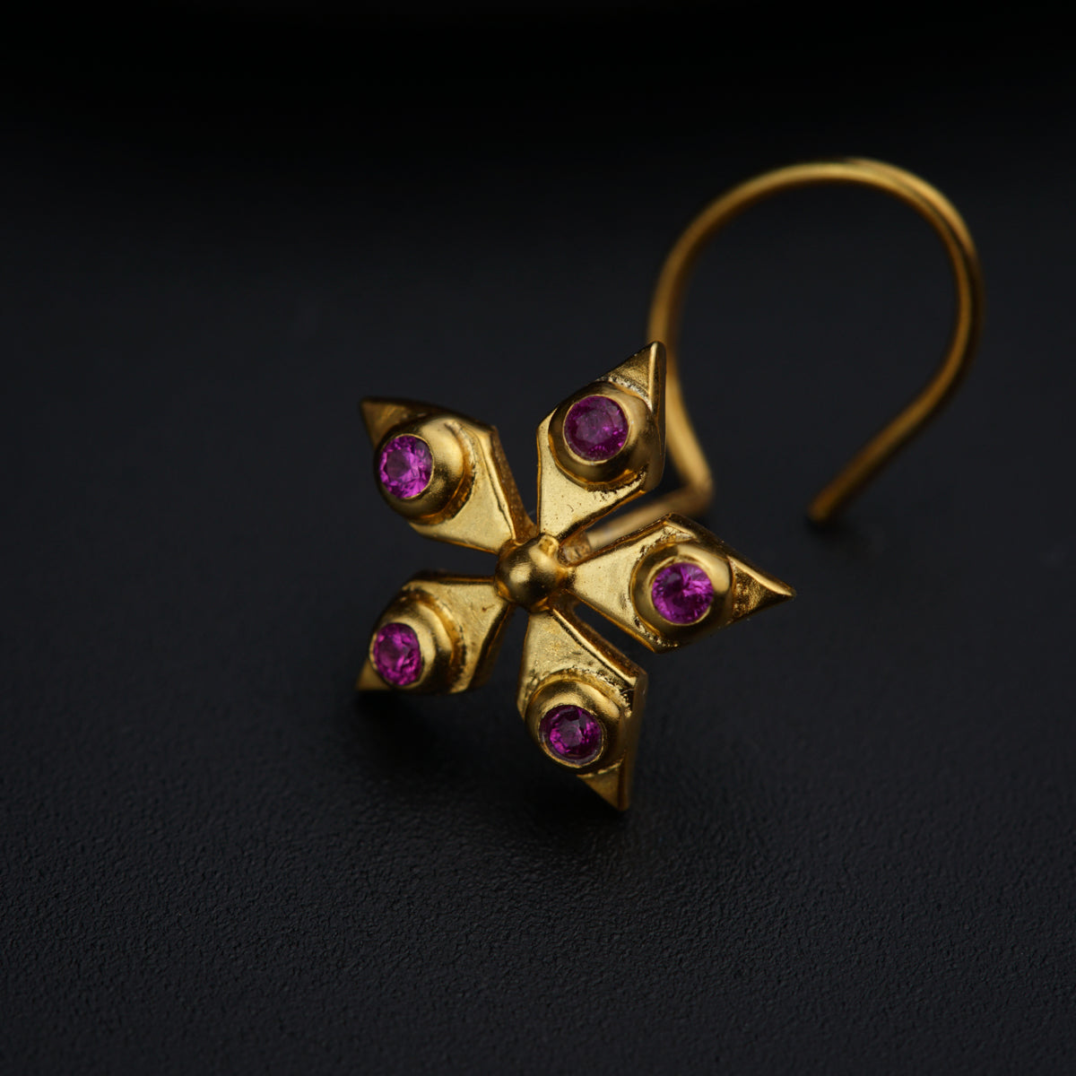 a pair of gold earrings with pink stones