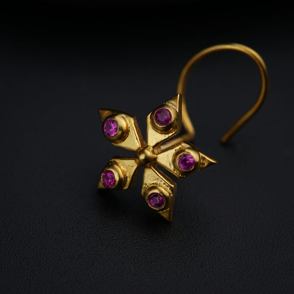 a pair of gold earrings with pink stones