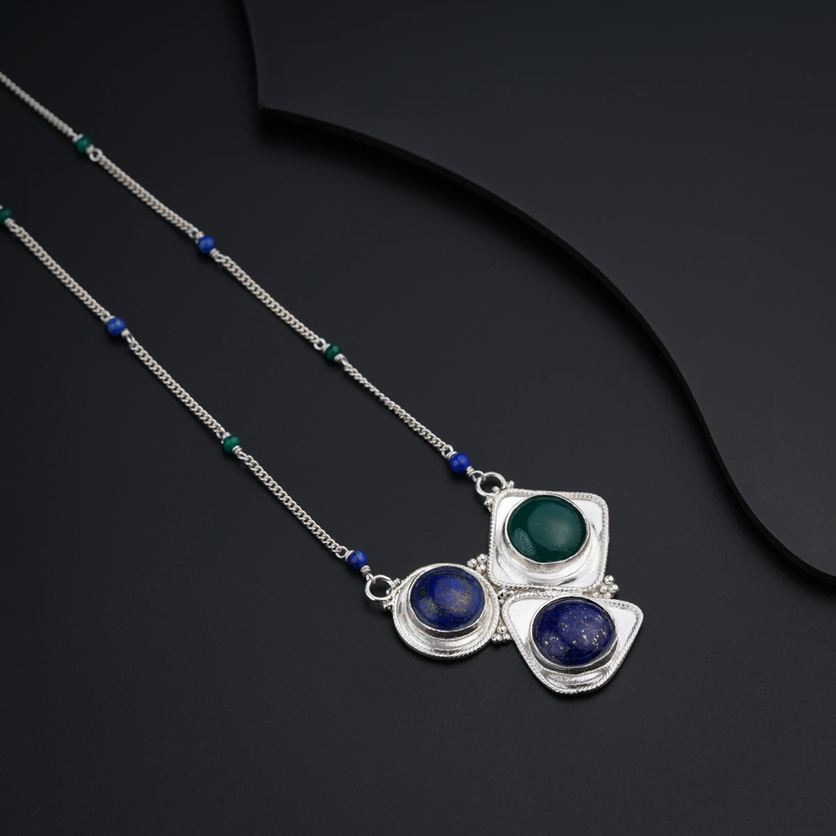 a couple of necklaces sitting on top of a table