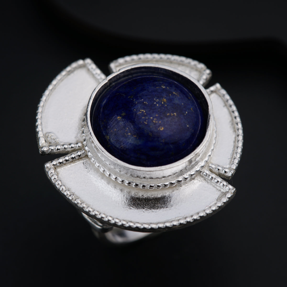 a ring with a blue stone in the middle of it