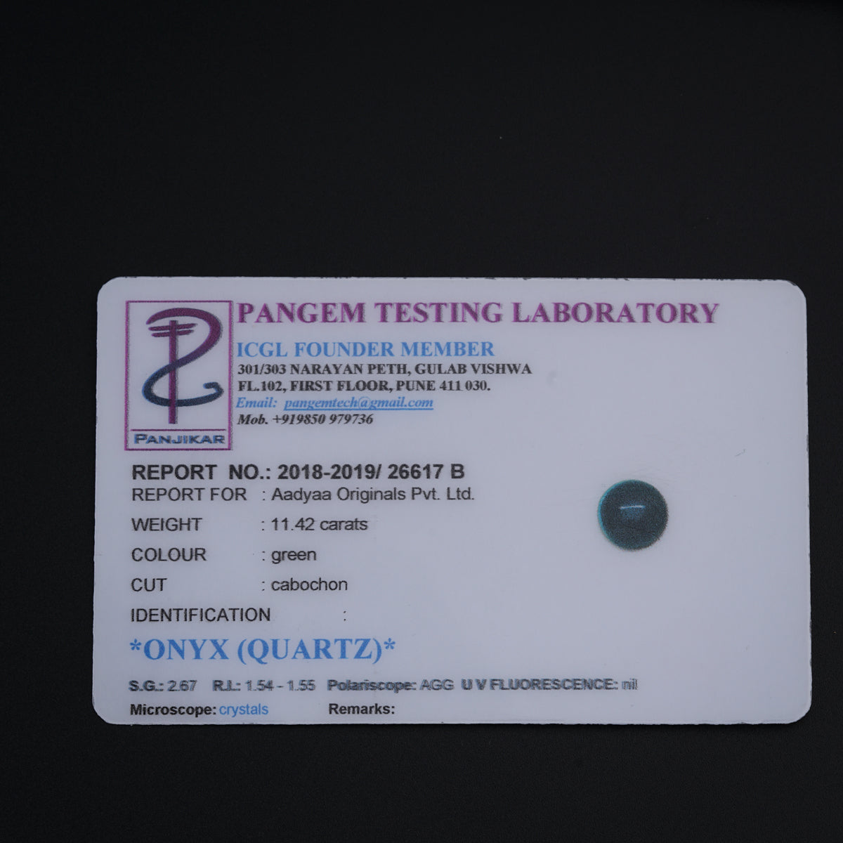 a tag on a black surface that says pangem testing laboratory