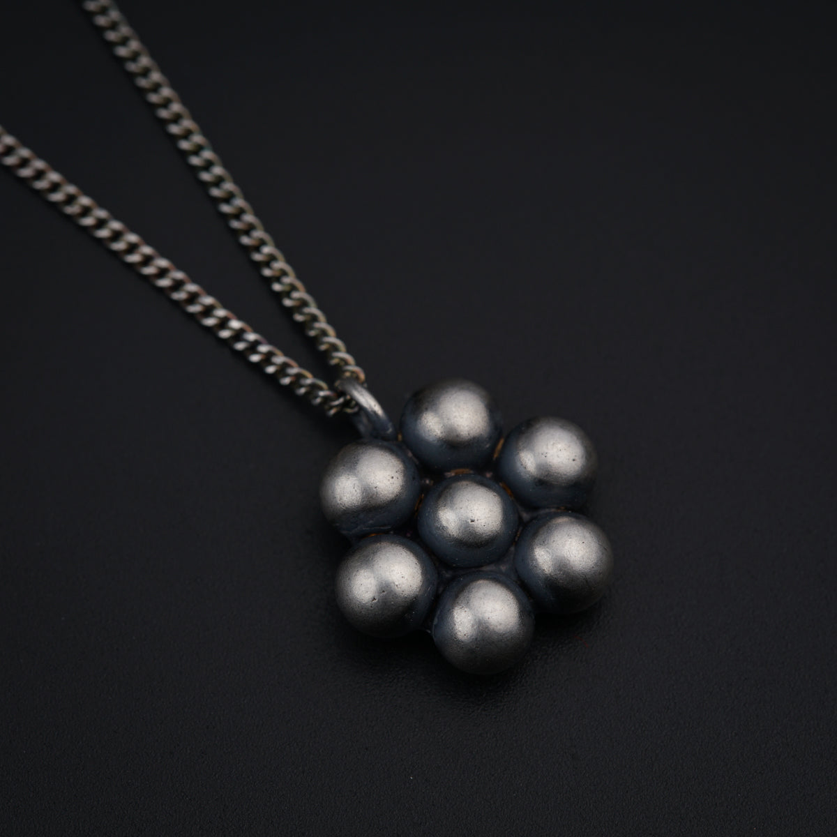 a bunch of silver balls on a chain