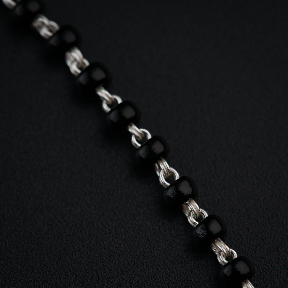 a close up of a chain on a black surface