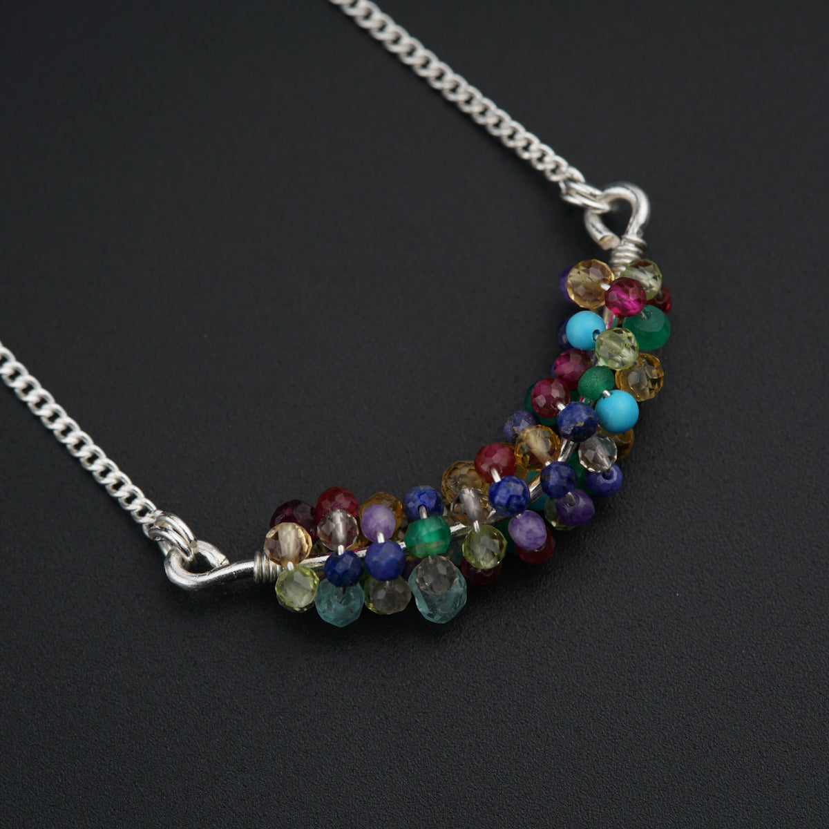 a multicolored beaded necklace on a chain