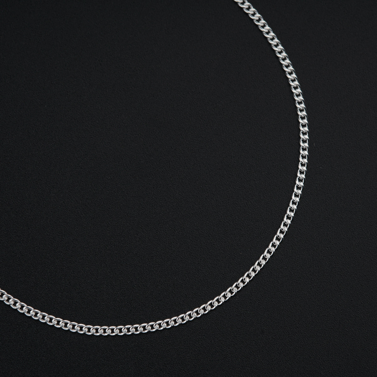 a silver chain on a black background